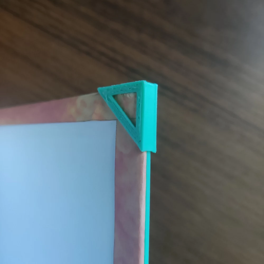 Close-up of a printed CoverForge corner pocket holding the rigid notebook cover