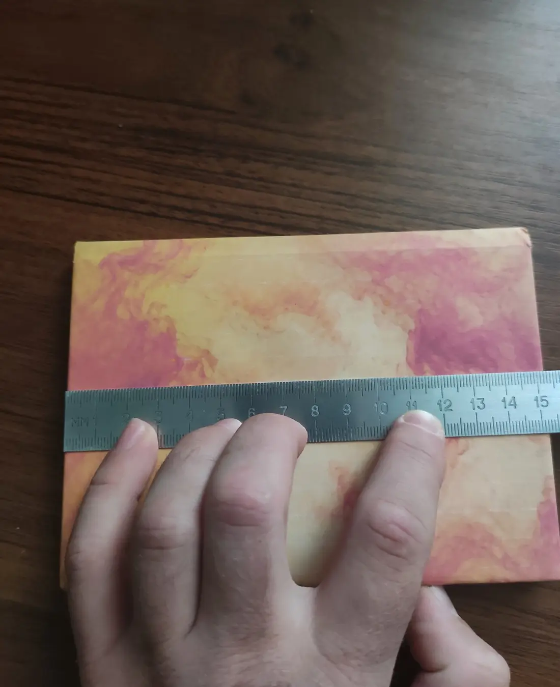 Ruler measuring the example notebook from bottom to top at 152 millimeters